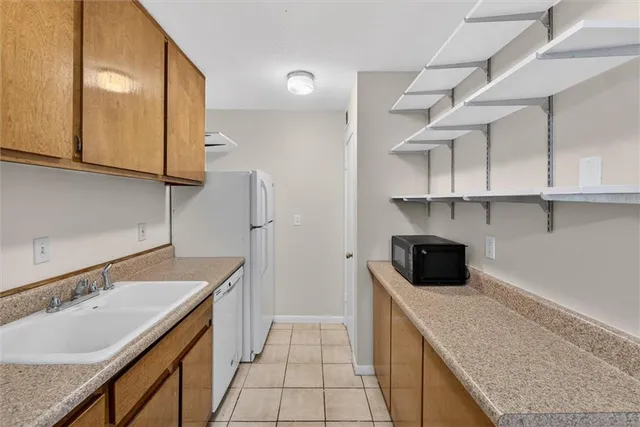 a kitchen with a sink a stove and cabinets