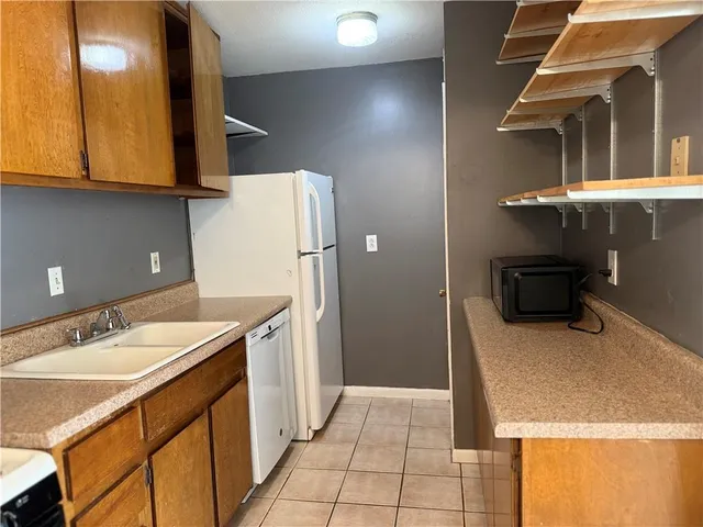 a kitchen with a sink a stove and refrigerator
