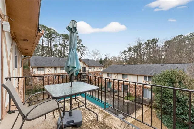 a view of a balcony with furniture