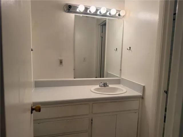 a bathroom with a sink and mirror