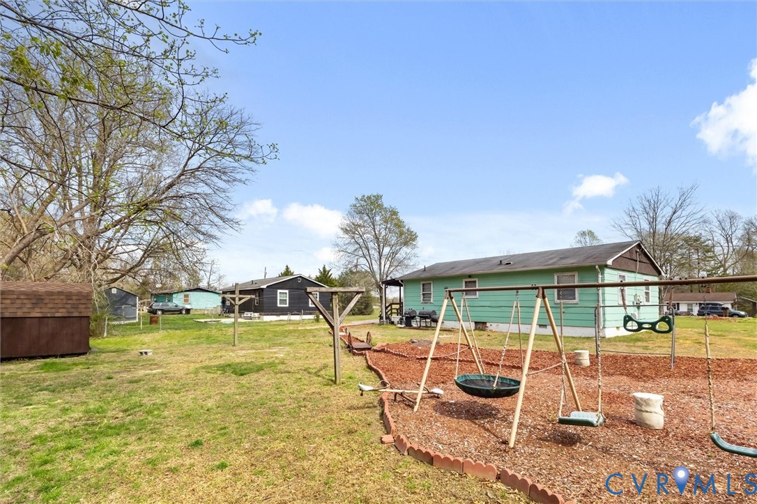 6436 Macedonia Road Woodford, VA 22580 - Photo 11 of 12 View of grassy yard featuring a playground