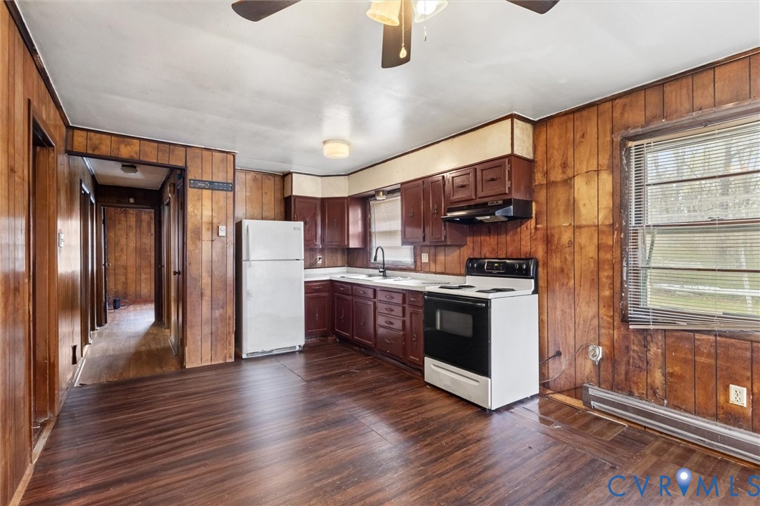 6436 Macedonia Road Woodford, VA 22580 - Photo 6 of 12 Kitchen featuring white appliances, wood walls, li