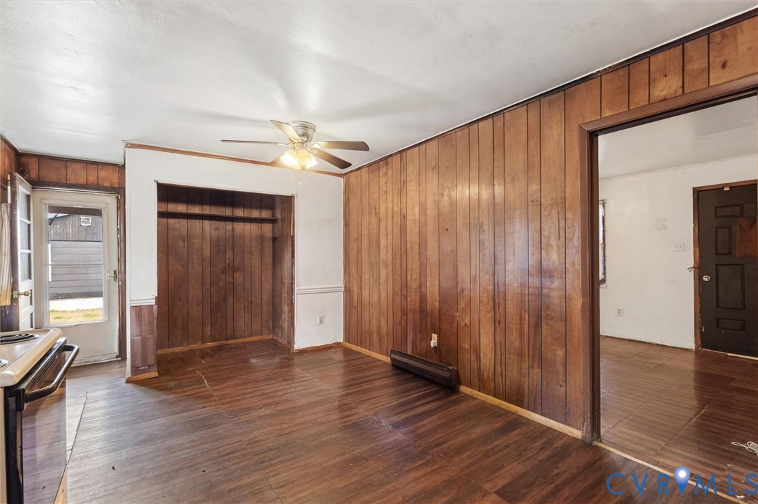 6436 Macedonia Road Woodford, VA 22580 - Photo 7 of 12 Unfurnished bedroom featuring wooden walls, dark w