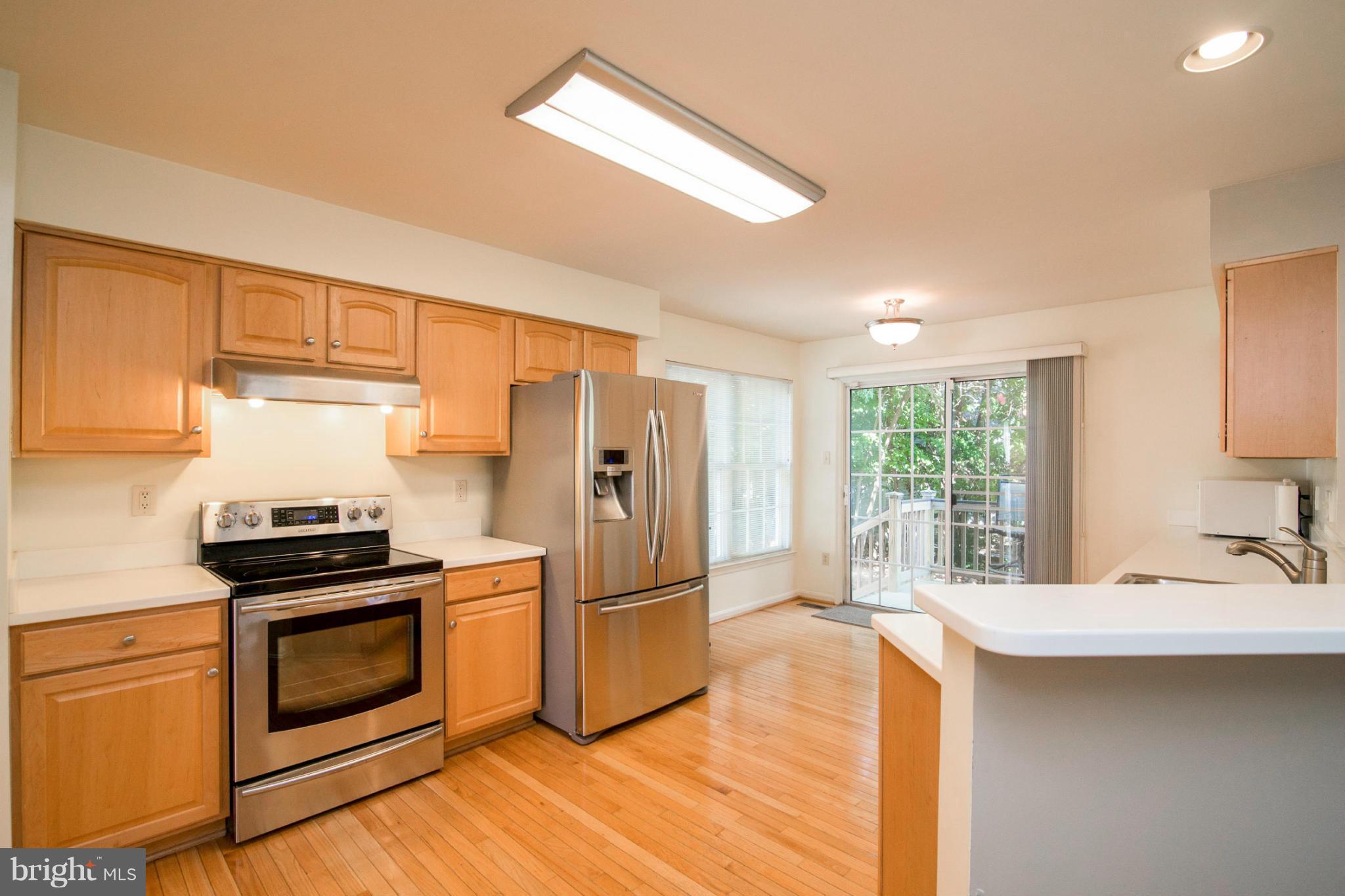 3044 Shoreline Boulevard Laurel, MD 20724 - Photo 2 of 13 a kitchen with granite countertop a stove a sink and a refrigerator