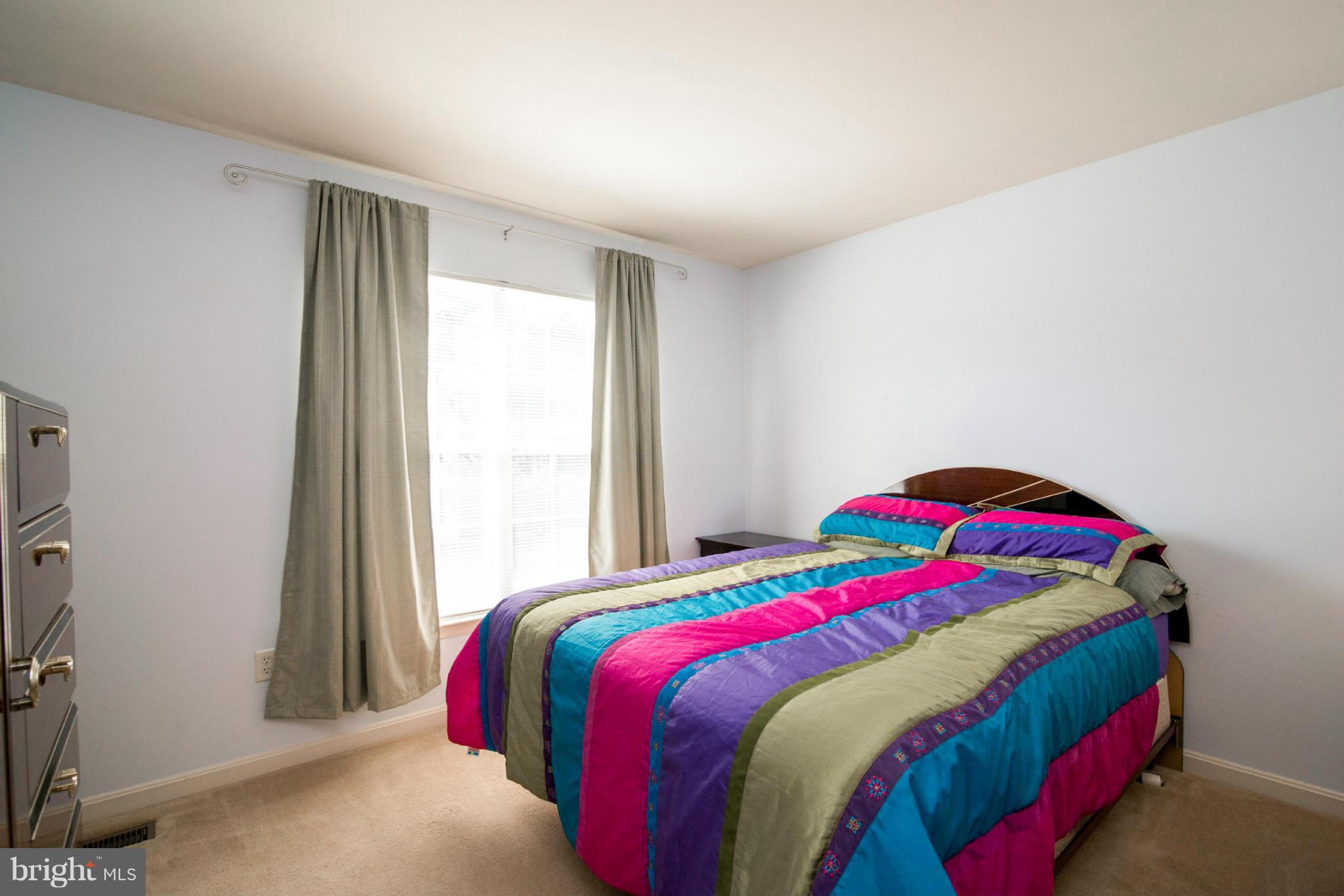 3044 Shoreline Boulevard Laurel, MD 20724 - Photo 9 of 13 a bedroom with a bed and a window