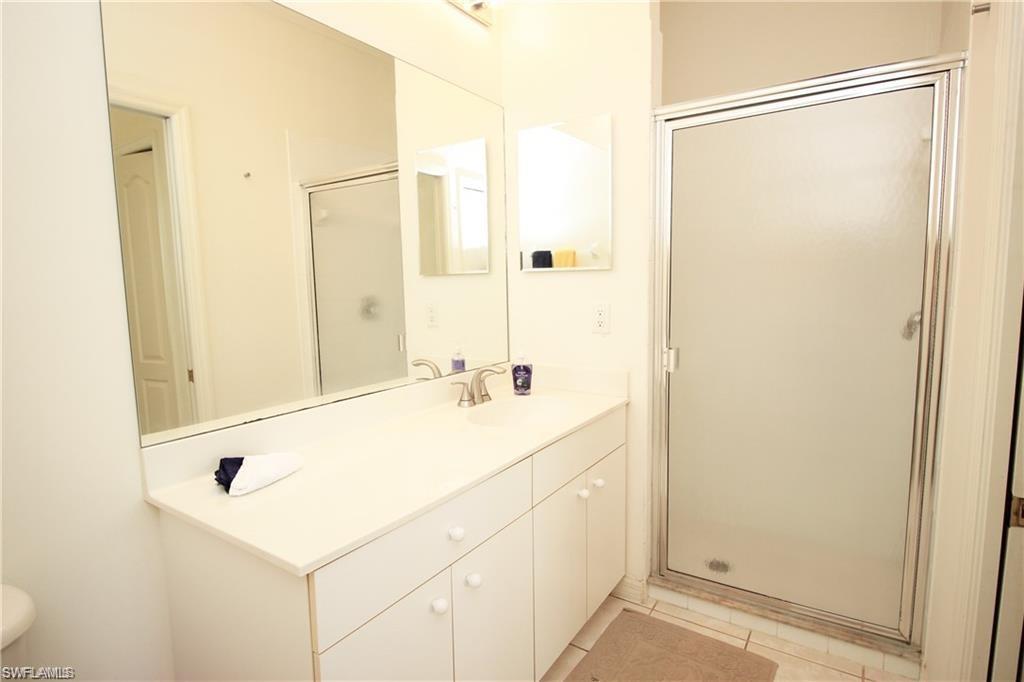 1736 Morning Sun Lane, Unit D6 Naples, FL 34119 - Photo 11 of 29 a bathroom with a sink and a shower