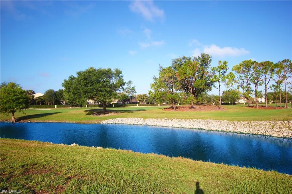 1736 Morning Sun Lane, Unit D6 Naples, FL 34119 - Photo 17 of 29 a view of a swimming pool and an outdoor space