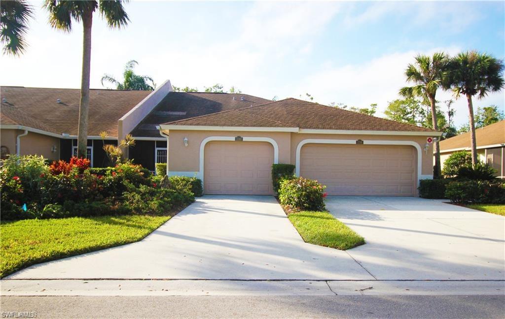 1736 Morning Sun Lane, Unit D6 Naples, FL 34119 - Photo 2 of 29 front view of a house with a yard and potted plants
