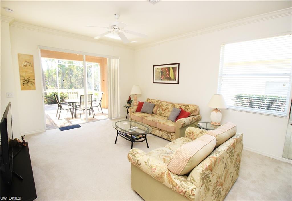 1736 Morning Sun Lane, Unit D6 Naples, FL 34119 - Photo 8 of 29 a living room with furniture and a flat screen tv