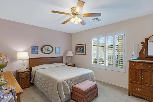 a bedroom with a bed dresser and a window