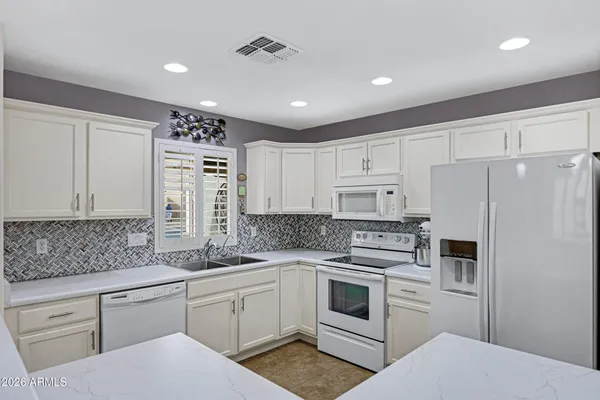 a kitchen with cabinets appliances and a counter space