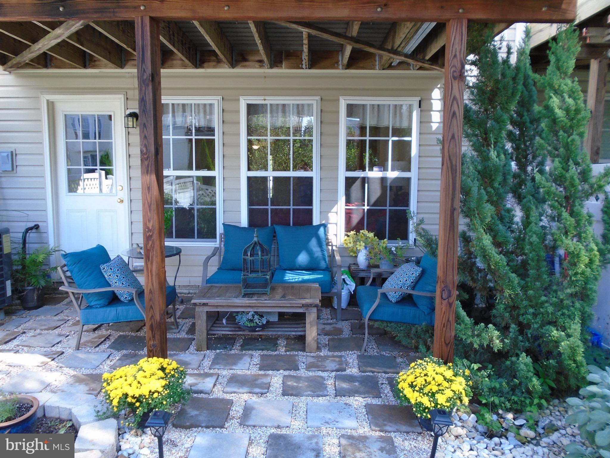 1243 Steed Street Ranson, WV 25438 - Photo 29 of 29 a view of a patio with table and chairs potted plants