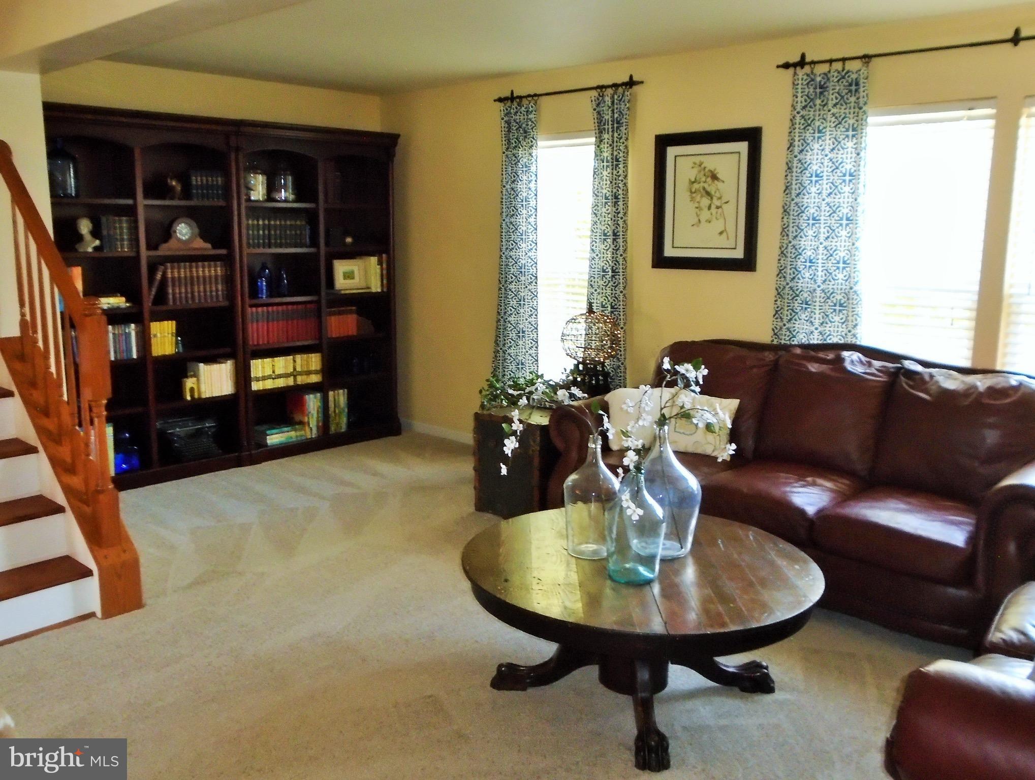 1243 Steed Street Ranson, WV 25438 - Photo 8 of 29 a living room with furniture and a table