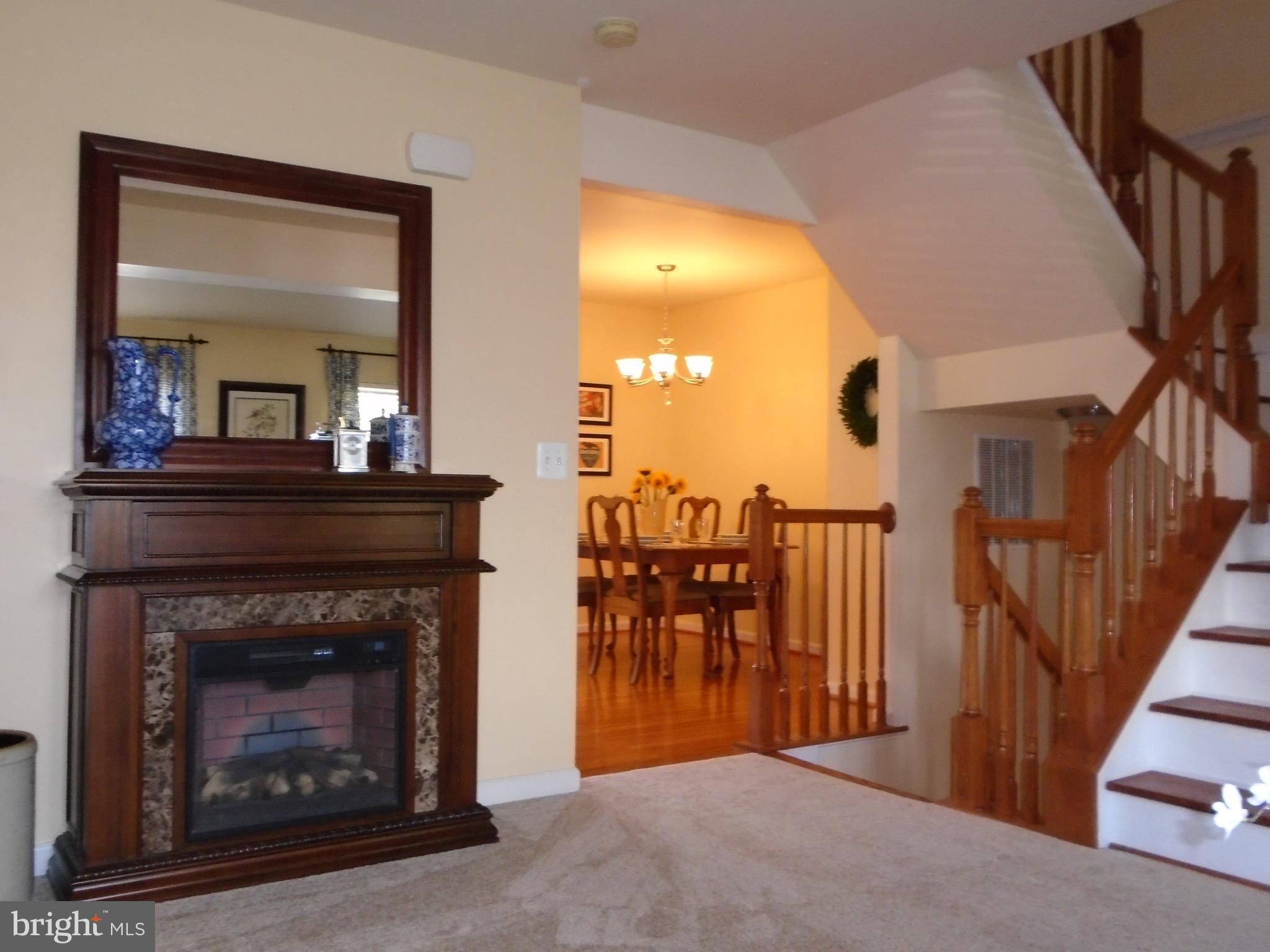 1243 Steed Street Ranson, WV 25438 - Photo 10 of 29 a view of a livingroom with furniture and a fireplace