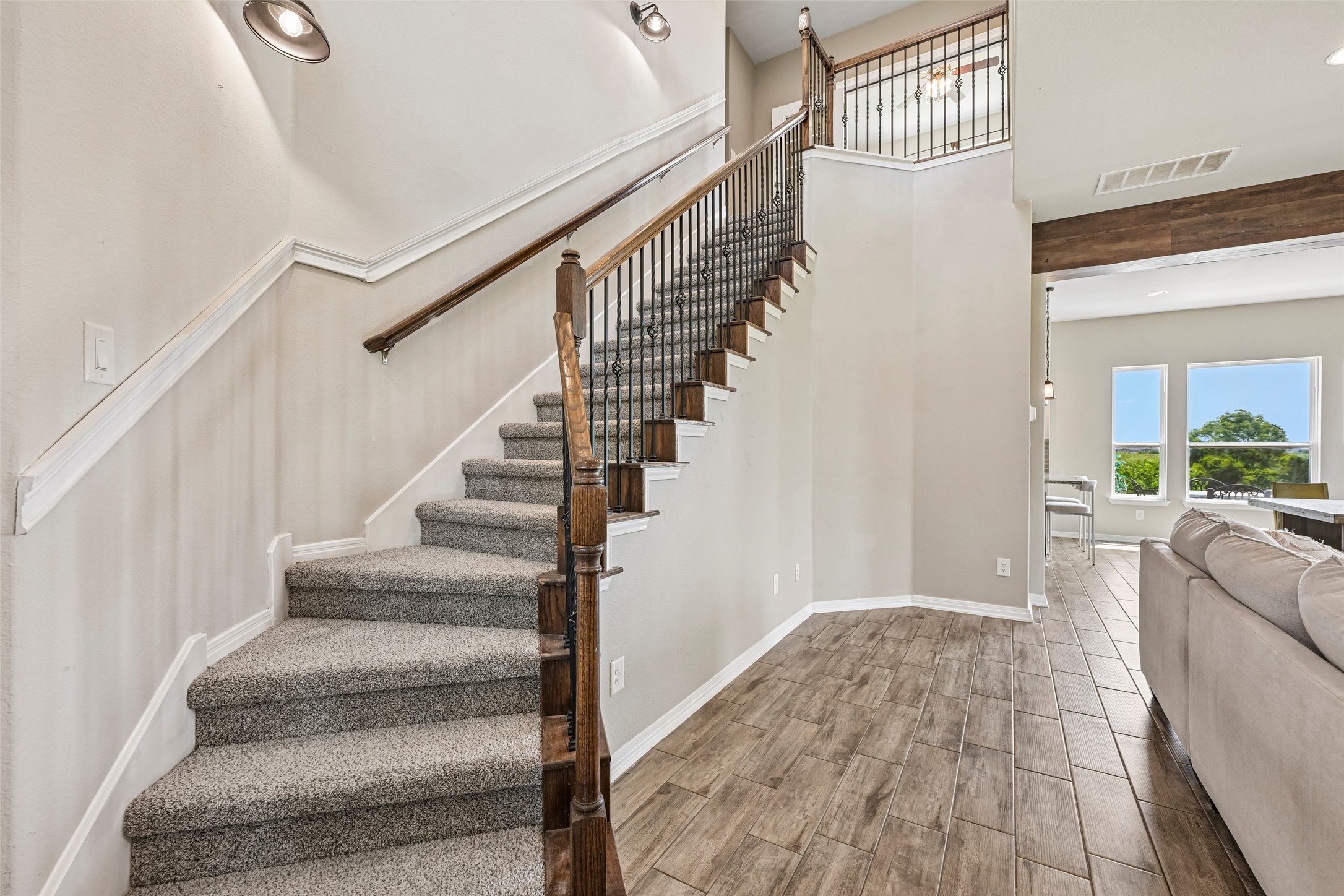 1297 Harwell Loop Kyle, TX 78640 - Photo 17 of 39 A grand staircase with elegant wrought iron detailing ascends to the upper level.