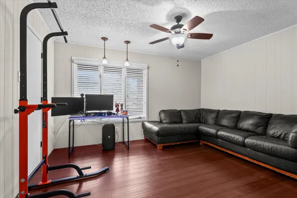 a living room with furniture and a wooden floor