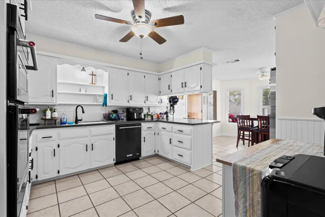 a kitchen with stainless steel appliances a refrigerator and a stove top oven