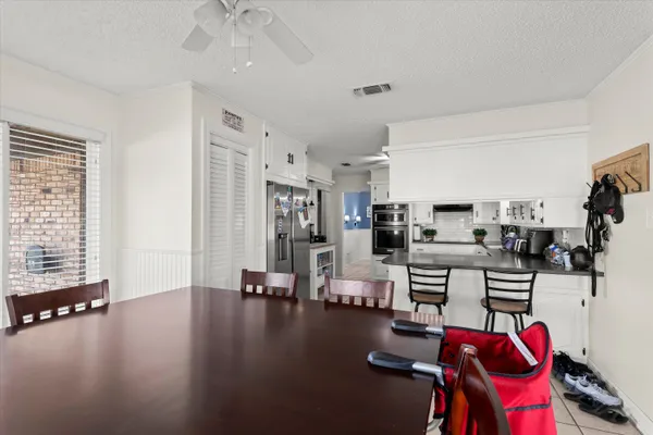 a view of a dining room with furniture and chandelier