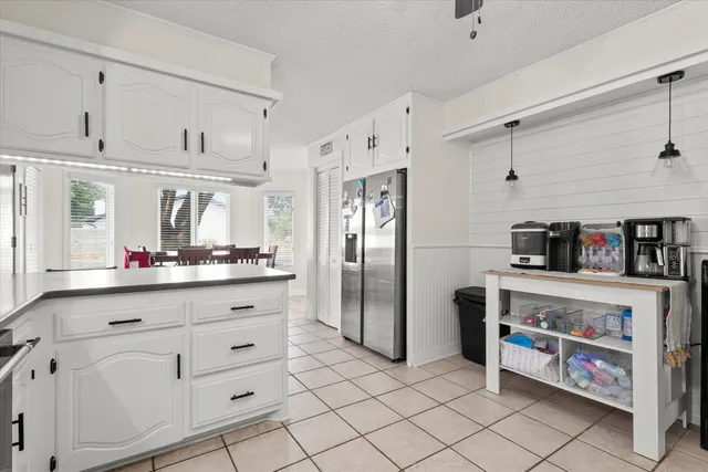 a spacious bedroom with a bed and a chandelier