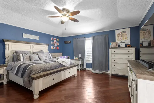 a bedroom with furniture and a flat screen tv