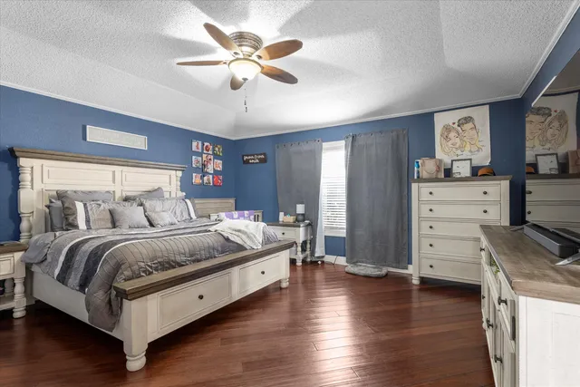 a bedroom with furniture and a flat screen tv