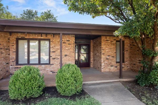 a view of a hallway with wooden floor and closet