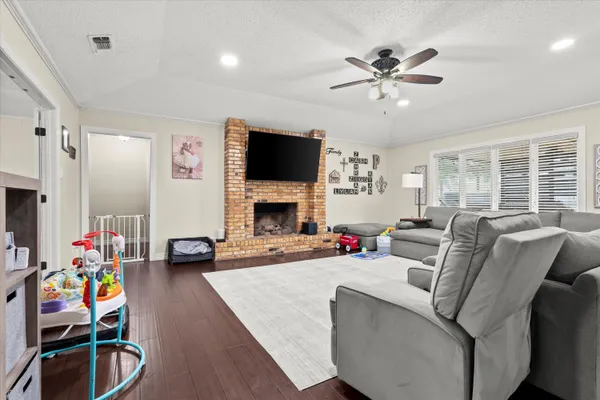a living room with furniture and wooden floor