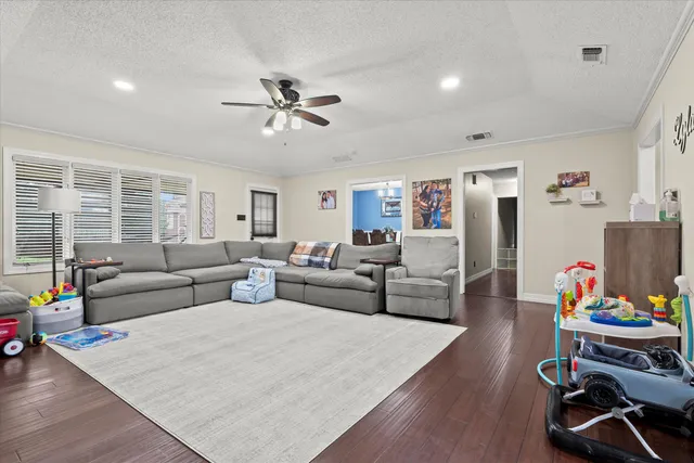 a living room with furniture and a chandelier