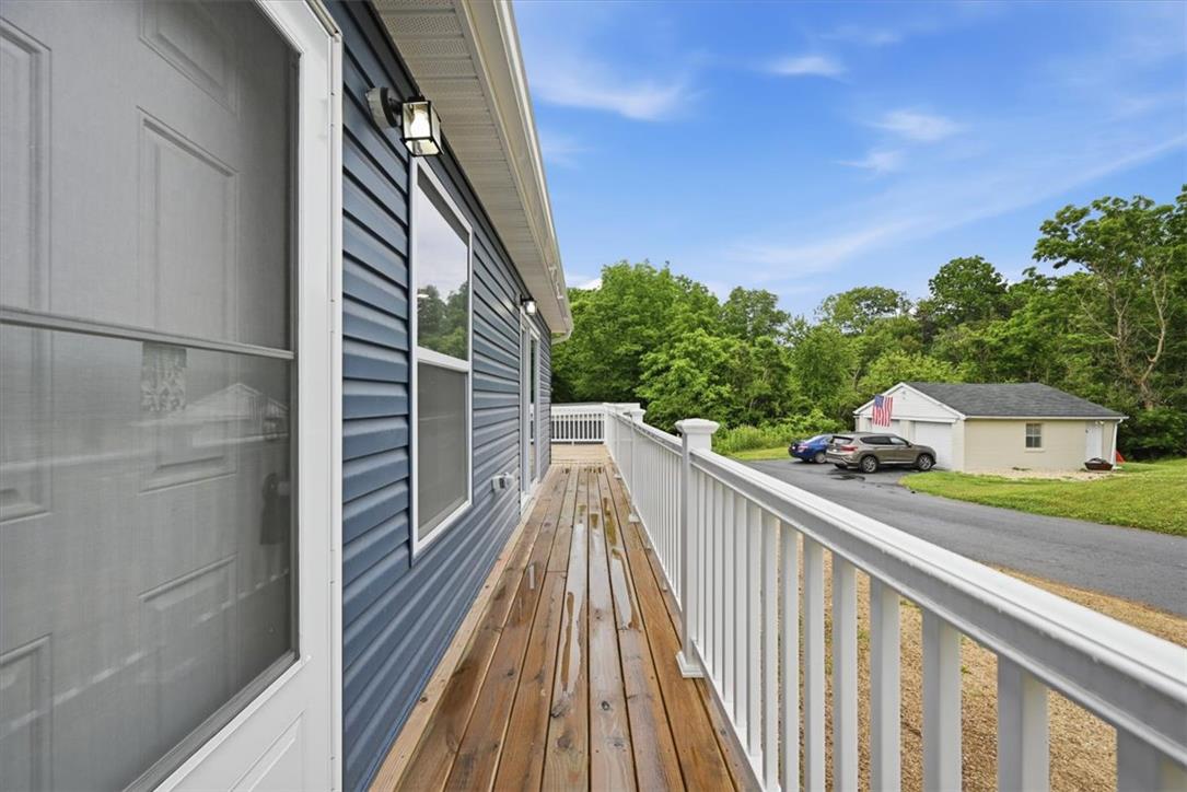5641 North Coplay Road Whitehall, PA 18052 - Photo 53 of 68 A spacious wooden deck provides generous outdoor living space with views of the surrounding natural landscape.