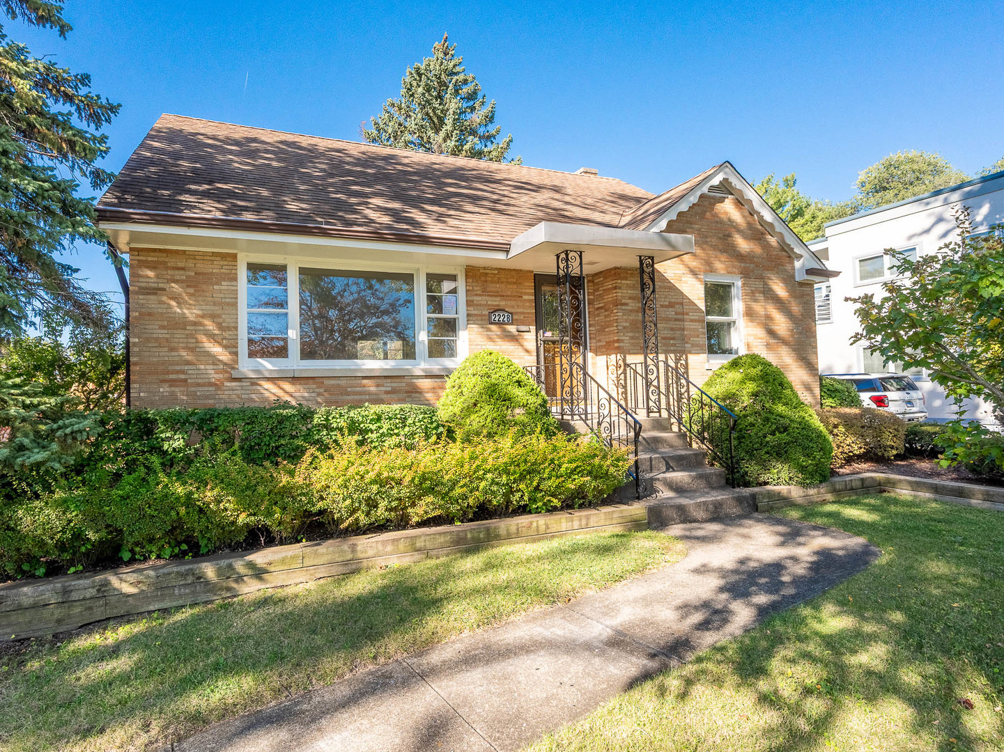 a view of a house with a yard and plants