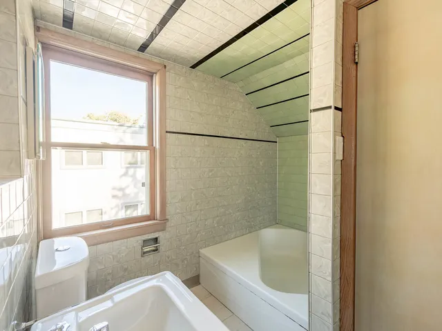 a bathroom with a bathtub and window