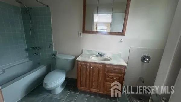 a bathroom with a sink toilet and a mirror