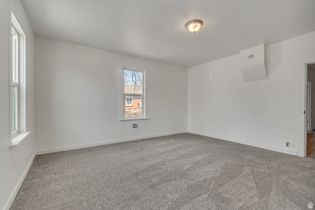 8831 South 400 East Sandy, UT 84070 - Photo 15 of 26 Carpeted spare room featuring baseboards