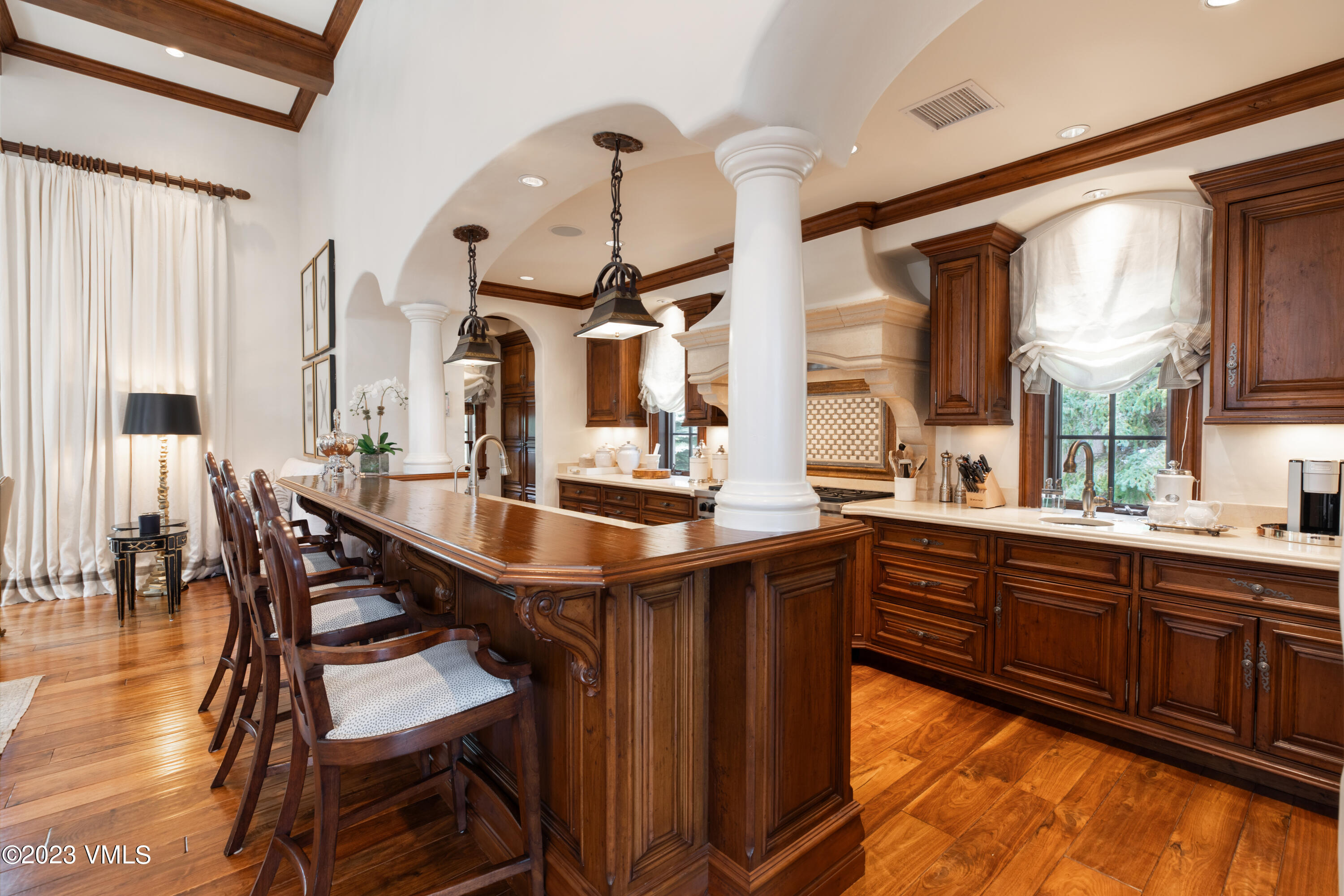 155 Arrowhead Drive Edwards, CO 81632 - Photo 7 of 45 a dining hall with stainless steel appliances kitchen island granite countertop a table chairs and a large window