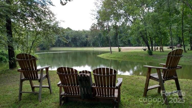 2482 Paddock Circle Morganton, NC 28655 - Photo 6 of 13 a view of a lake with table and chairs