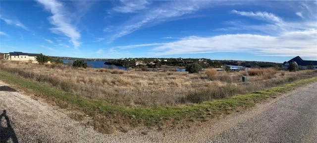 a view of a lake with houses in the back