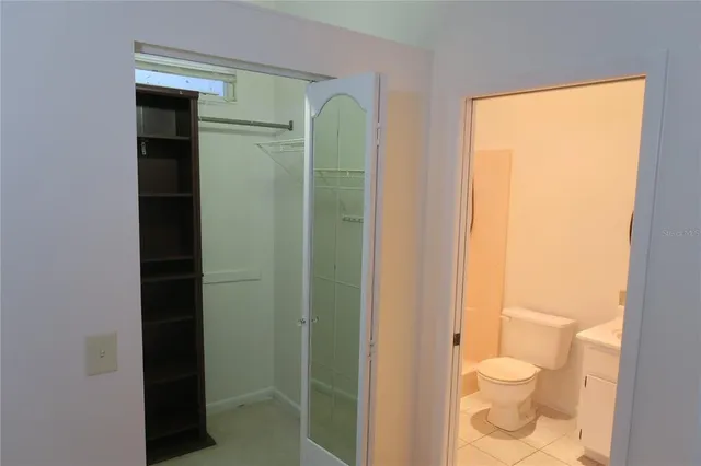 a bathroom with a granite countertop shower toilet and sink