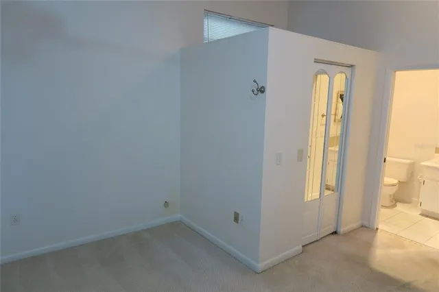 a view of a hallway with wooden floor and a window