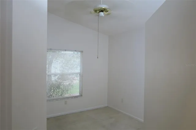 a view of a room with floor to ceiling windows and wooden floor