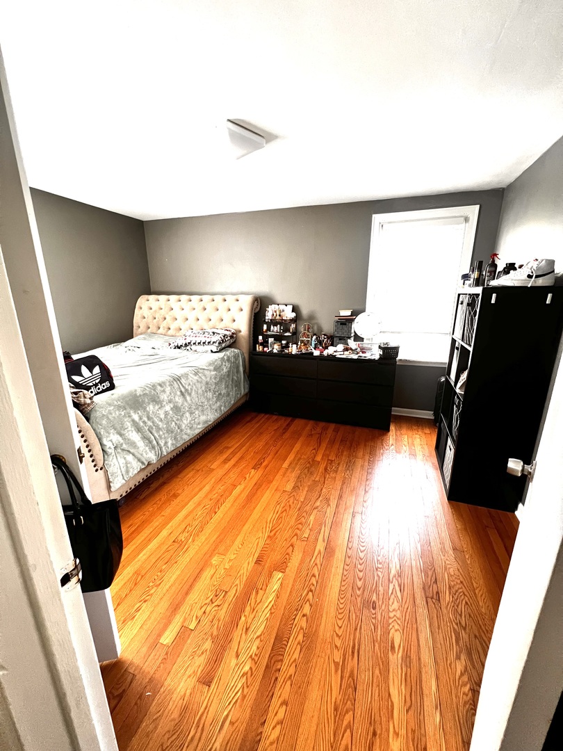 18510 Dixie Highway Homewood, IL 60430 - Photo 8 of 11 a bedroom with a bed and wooden floor