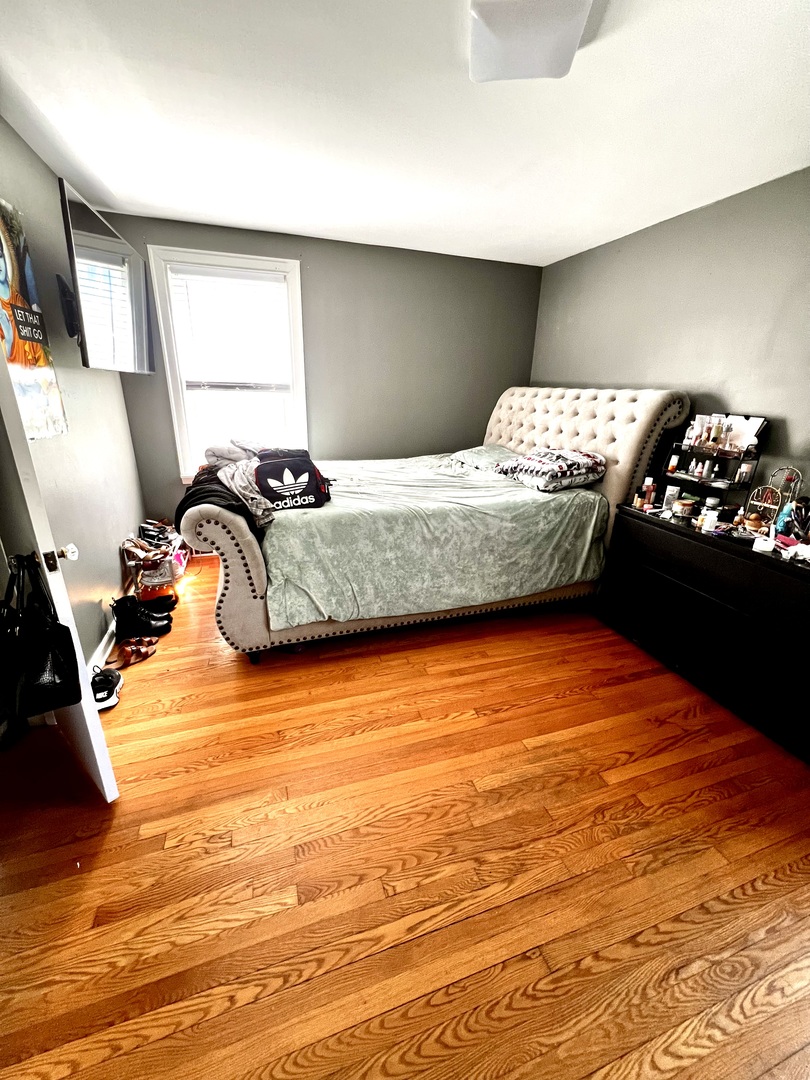 18510 Dixie Highway Homewood, IL 60430 - Photo 9 of 11 a bedroom with a bed and dresser with wooden floor