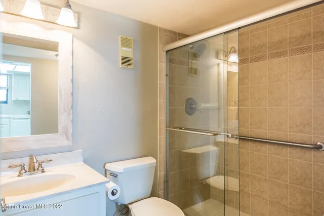 a bathroom with a shower toilet and sink