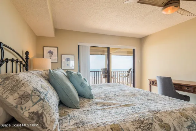 a bed sitting in a bedroom next to a window with a bedroom