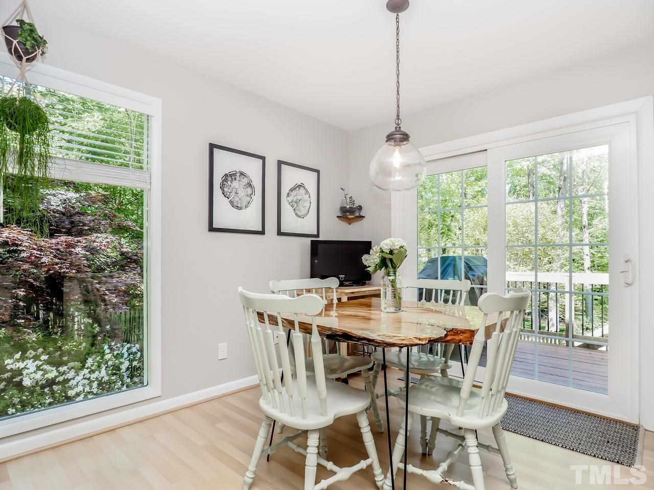 2012 Fawndale Drive Raleigh, NC 27612 - Photo 15 of 27 a view of a dining room with furniture window and outside view