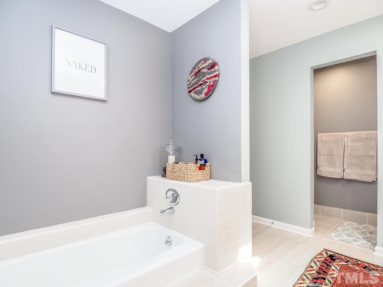 2012 Fawndale Drive Raleigh, NC 27612 - Photo 21 of 27 a bathroom with a bathtub and a shower