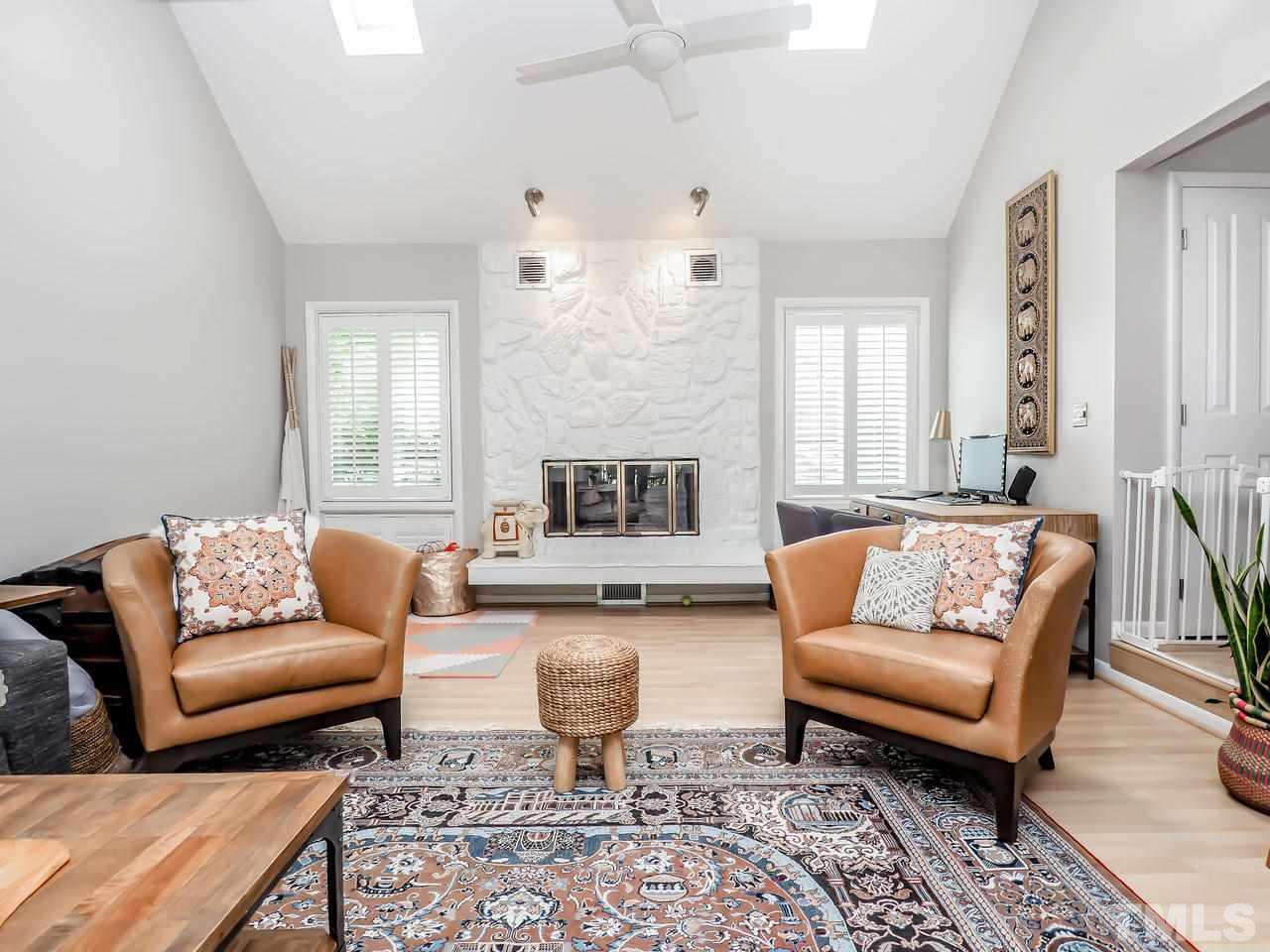 2012 Fawndale Drive Raleigh, NC 27612 - Photo 6 of 27 a living room with furniture wooden floor and a fireplace