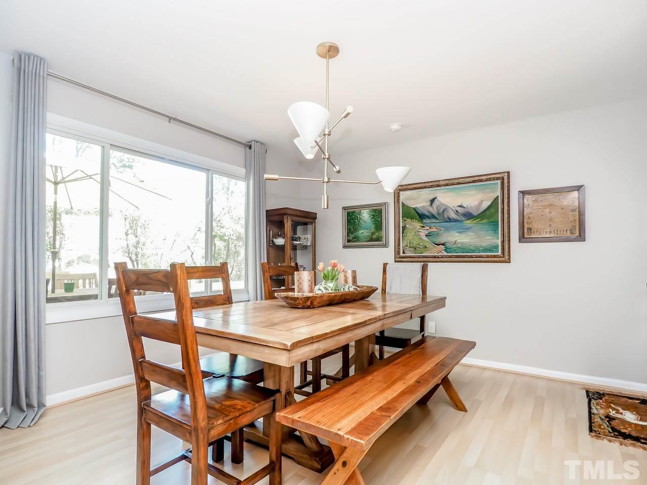2012 Fawndale Drive Raleigh, NC 27612 - Photo 7 of 27 a dining room with wooden floor and a chandelier