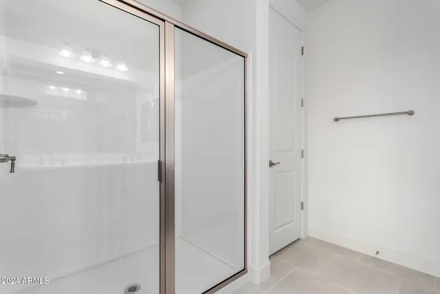 a bathroom with a glass shower door