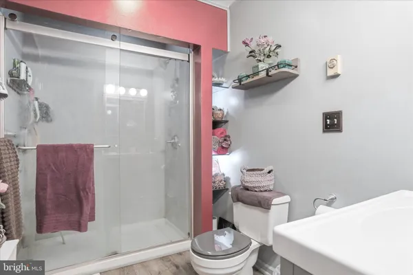 a living room with furniture and a refrigerator