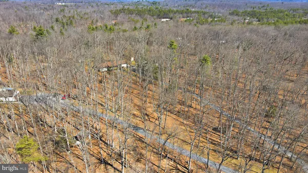 a view of a dry yard with mountains in the background